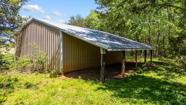 view of pole building featuring fence and a carport