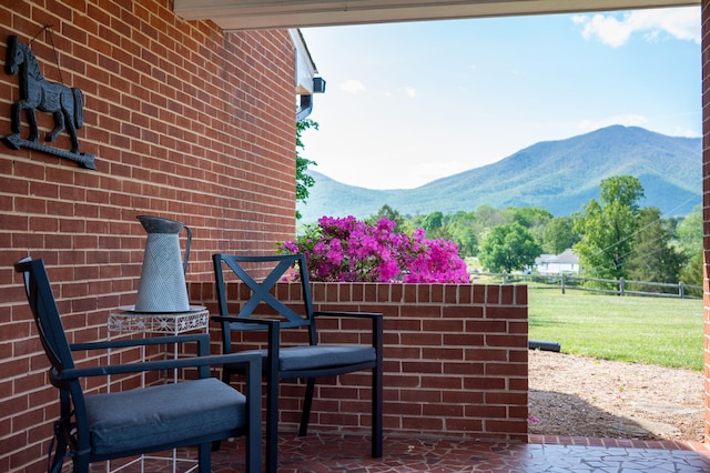 view of patio / terrace featuring fence and a mountain view