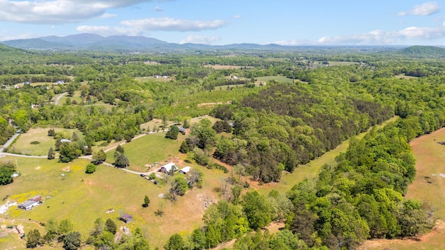 aerial view with a wooded view and a mountain view