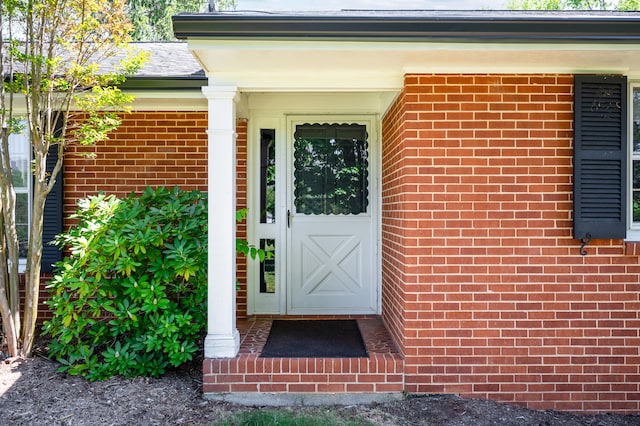 property entrance with brick siding