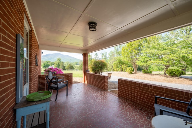 view of patio / terrace featuring covered porch and a mountain view