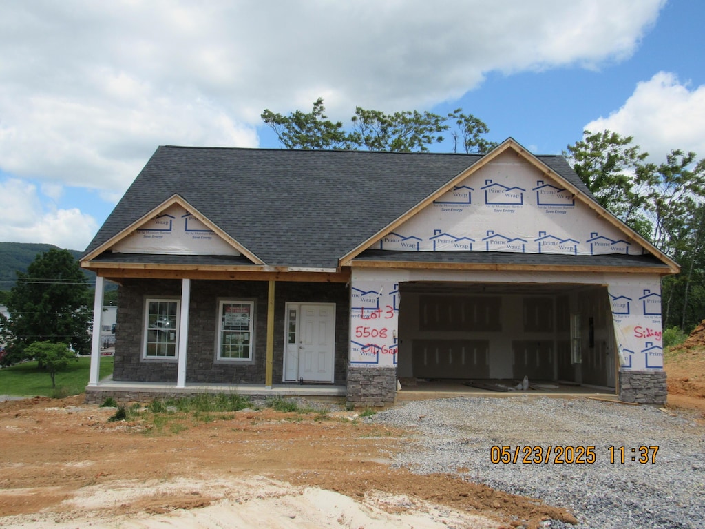 5598 Old Grove Ln, Salem, VA 24153 - property in mid-construction with dirt driveway, a porch, an attached garage, and stone siding