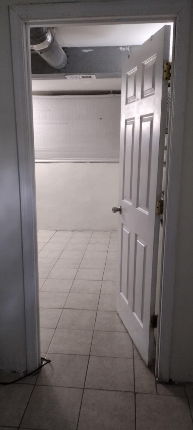 hallway featuring tile patterned flooring