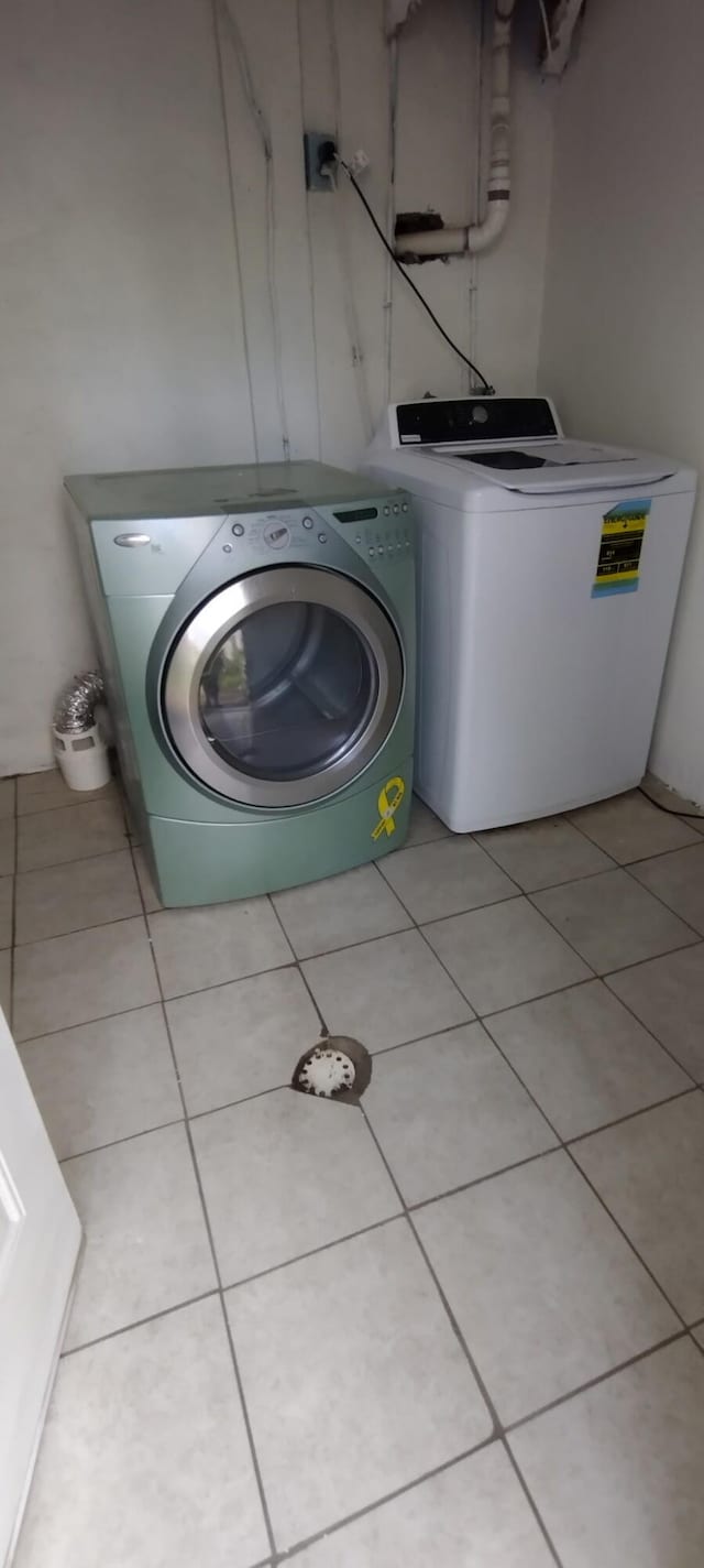 laundry area featuring independent washer and dryer, laundry area, and light tile patterned floors