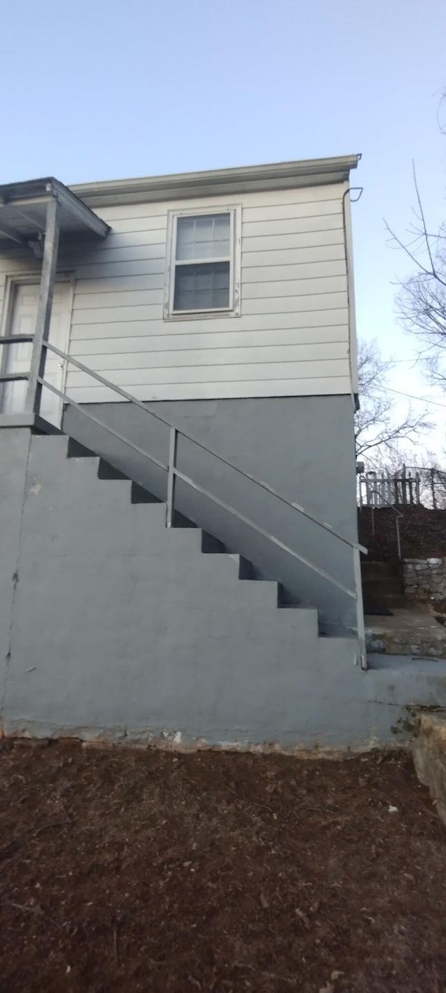 view of side of property featuring stairs