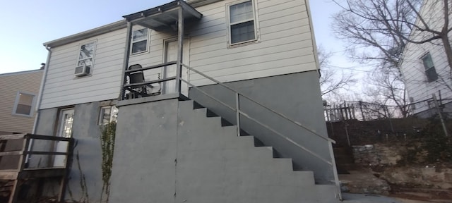 rear view of property featuring stairs