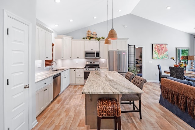 308 Buck Run Dr, Moneta, VA 24121 - kitchen with stainless steel appliances, a sink, a kitchen breakfast bar, a kitchen island, and light stone counters