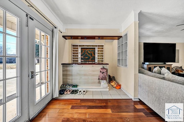interior space featuring crown molding, a ceiling fan, and tile patterned floors
