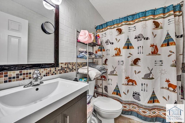 bathroom with decorative backsplash, tile walls, vanity, toilet, and a shower with shower curtain