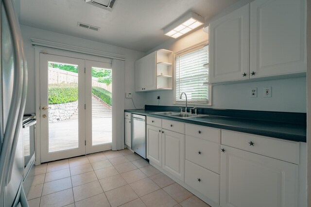 2509 Sweetbrier Ave SW, Roanoke, VA 24015 - kitchen featuring stainless steel dishwasher, a sink, plenty of natural light, and dark countertops