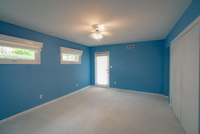 2509 Sweetbrier Ave SW, Roanoke, VA 24015 - unfurnished bedroom featuring visible vents, baseboards, multiple windows, and light colored carpet