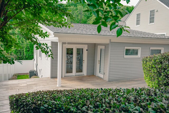 2509 Sweetbrier Ave SW, Roanoke, VA 24015 - view of exterior entry featuring fence, a wooden deck, a shingled roof, and cooling unit