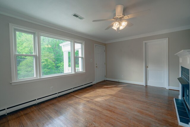 2509 Sweetbrier Ave SW, Roanoke, VA 24015 - unfurnished living room featuring a wealth of natural light, a baseboard radiator, wood finished floors, and visible vents
