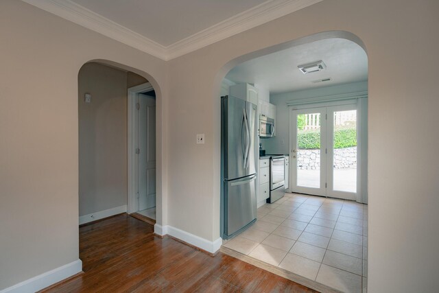 2509 Sweetbrier Ave SW, Roanoke, VA 24015 - interior space featuring crown molding, baseboards, white cabinetry, french doors, and stainless steel appliances