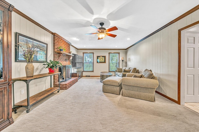 living room featuring crown molding, carpet floors, a ceiling fan, a fireplace, and baseboards