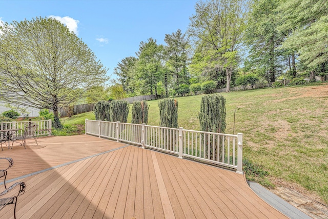 wooden terrace featuring view of wooded area