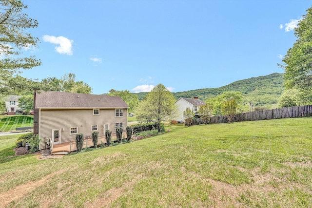 view of yard with a deck with mountain view