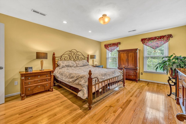 bedroom with light wood-style floors, baseboards, and recessed lighting