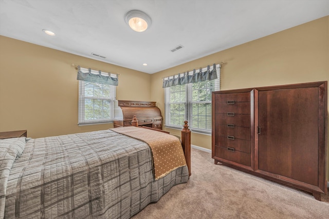 bedroom featuring light colored carpet, baseboards, and recessed lighting