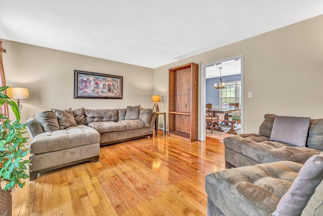 living area with light wood-style flooring and a chandelier