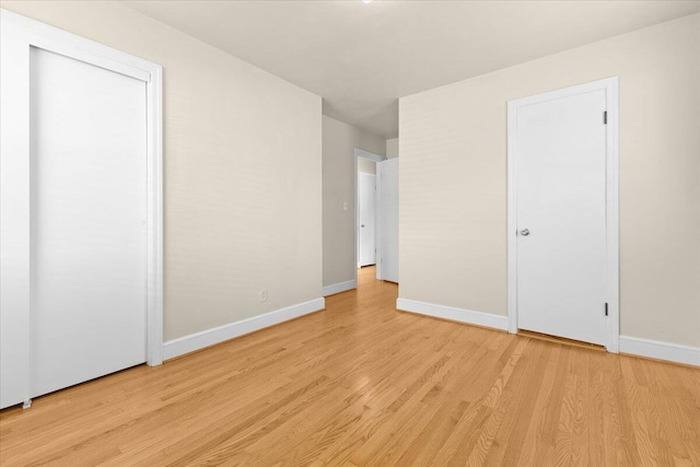 unfurnished bedroom featuring baseboards and light wood finished floors