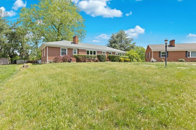 2738 Thorndale St SW, Roanoke, VA 24015 - view of front of home featuring a chimney, brick siding, and a front lawn