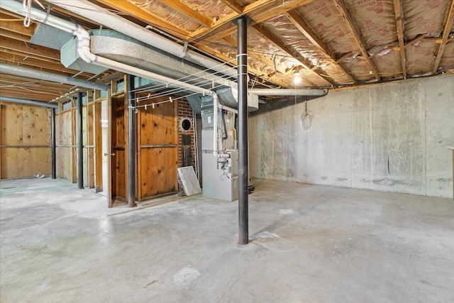 unfinished below grade area featuring heating unit