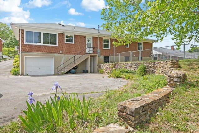 2738 Thorndale St SW, Roanoke, VA 24015 - single story home featuring fence, asphalt driveway, a garage, brick siding, and stairs