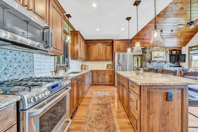 890 Blain Rd, Buchanan, VA 24066 - kitchen with appliances with stainless steel finishes, a sink, open floor plan, light wood finished floors, and a kitchen island