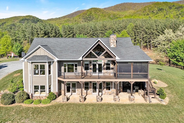 890 Blain Rd, Buchanan, VA 24066 - back of house with stone siding, a patio, a chimney, and a lawn