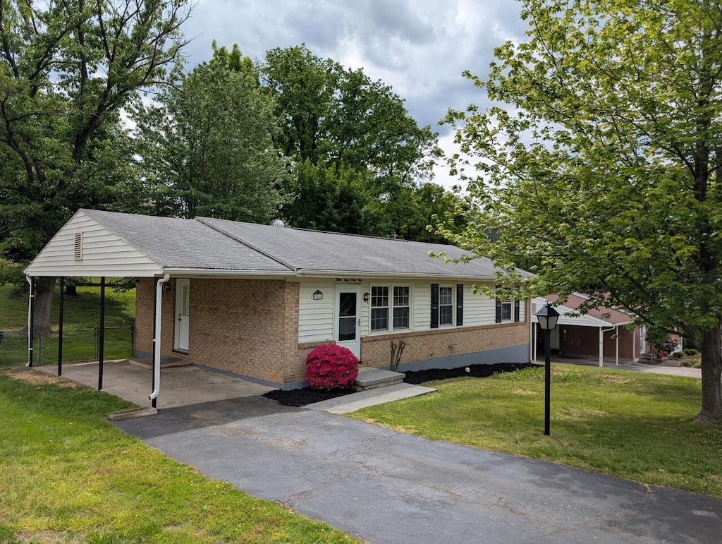 3844 Old Stevens Rd NW, Roanoke, VA 24017 - ranch-style home with brick siding, a front lawn, an attached carport, and asphalt driveway