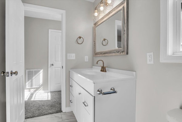 bathroom featuring visible vents, marble finish floor, and vanity