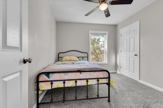 carpeted bedroom with baseboards and ceiling fan