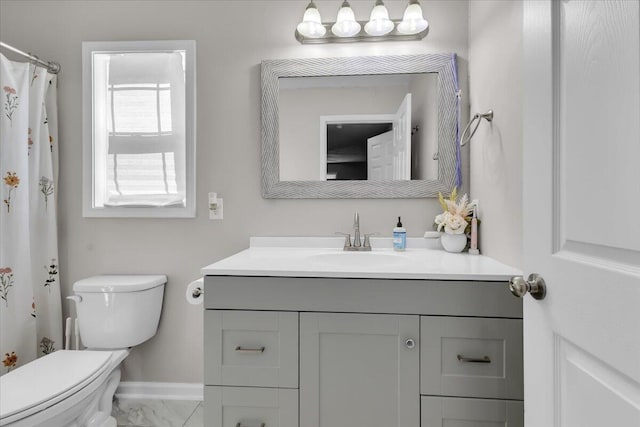 full bath with vanity, marble finish floor, baseboards, and toilet