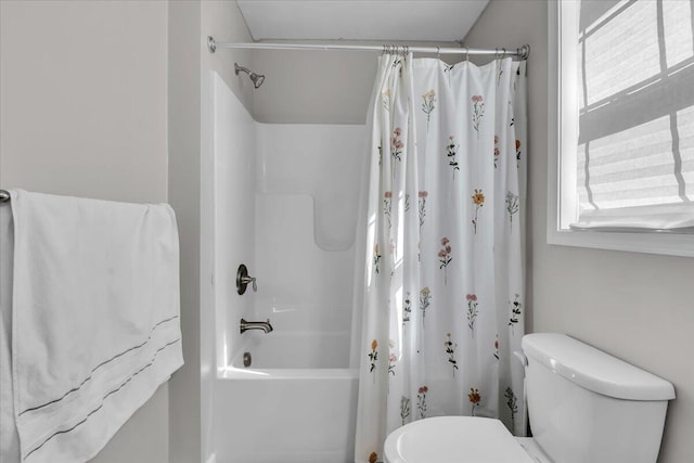 full bathroom featuring shower / bath combination with curtain and toilet