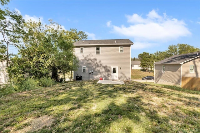 back of property with a patio and a yard