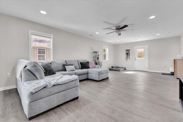 living room with baseboards, recessed lighting, ceiling fan, and wood finished floors