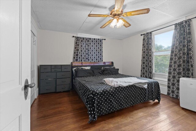 bedroom featuring a ceiling fan and wood finished floors