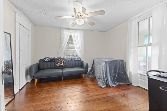 sitting room featuring ceiling fan and hardwood / wood-style floors