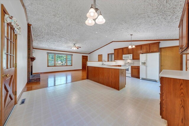 kitchen featuring visible vents, crown molding, white appliances, open floor plan, and brown cabinets