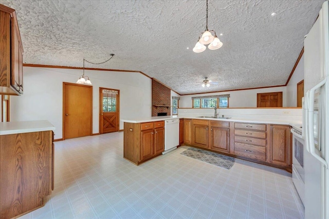 kitchen with brown cabinets, a notable chandelier, a sink, white appliances, and ornamental molding