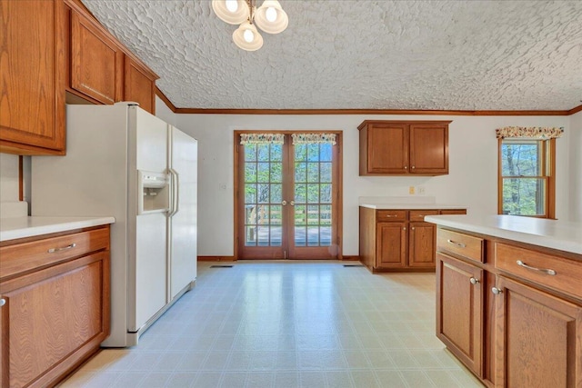 kitchen with french doors, light floors, brown cabinets, and white fridge with ice dispenser
