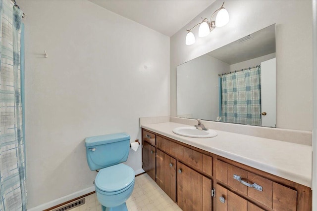 bathroom with vanity, toilet, tile patterned floors, baseboards, and visible vents