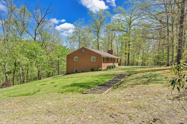 exterior space featuring a wooded view