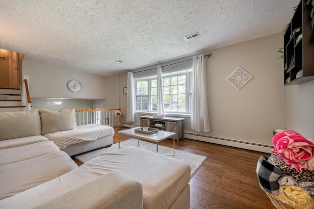 living area with a baseboard radiator, a textured ceiling, and wood finished floors