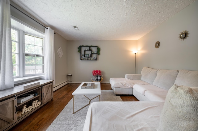 living area featuring a baseboard radiator, a textured ceiling, dark wood-style floors, and baseboards
