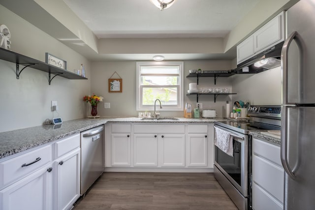 kitchen with open shelves, appliances with stainless steel finishes, a sink, under cabinet range hood, and white cabinets