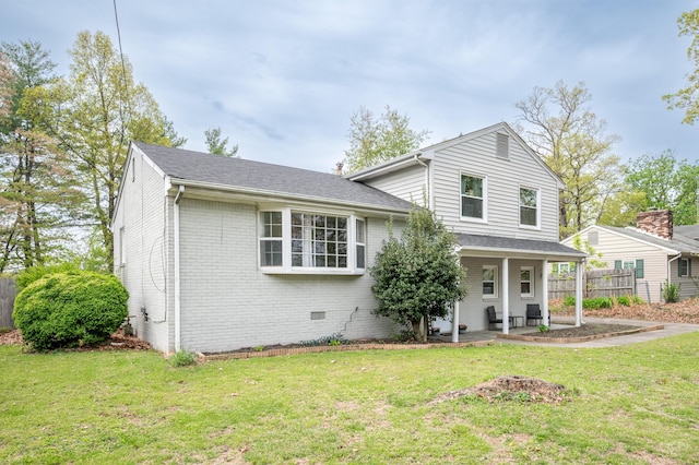 split level home featuring brick siding and a patio area