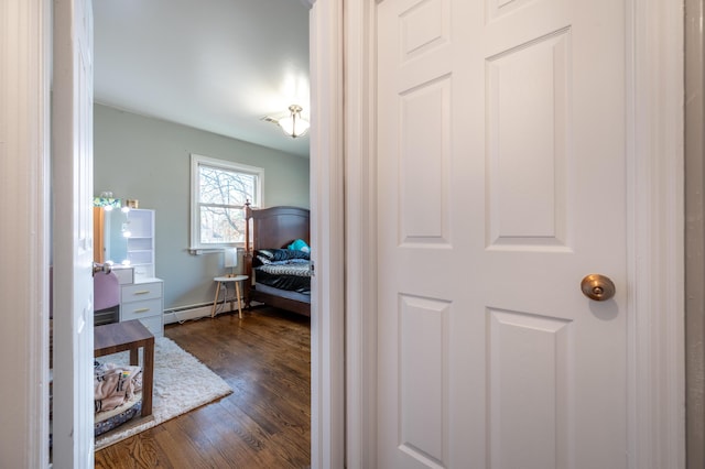 hallway with dark wood-style floors and a baseboard radiator