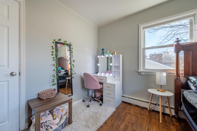 office space featuring a baseboard radiator and wood finished floors